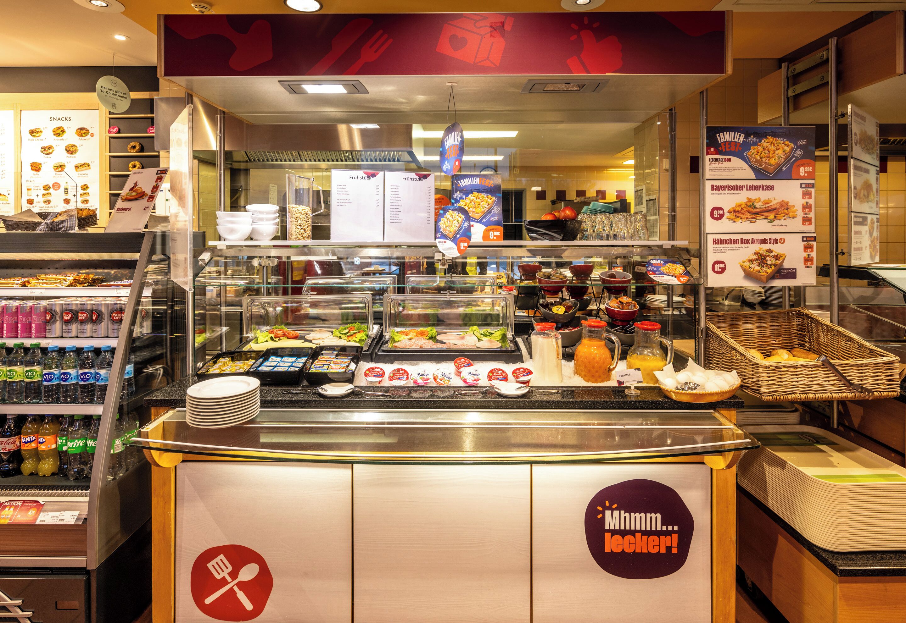 A buffet area with various food items and a beverage dispenser.