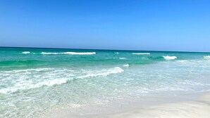 A beach with clear turquoise water and white sand. -  Luxury home with sugar white sand beach, family-friendly vacation rental house! (Destin)
