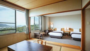 A hotel room with a large window, two beds, a desk, and a chair. - Kamenoi Hotel Kanonji (Kanonji)