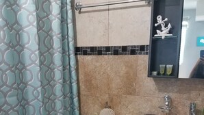 A bathroom with a toilet, sink, and mirror. - Caribbean getaway aguadilla (Aguadilla Pueblo)