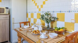 A dining table with a bowl of food, a pitcher, and a vase with flowers. - La Noria de Iznate by Ruralidays (Málaga)