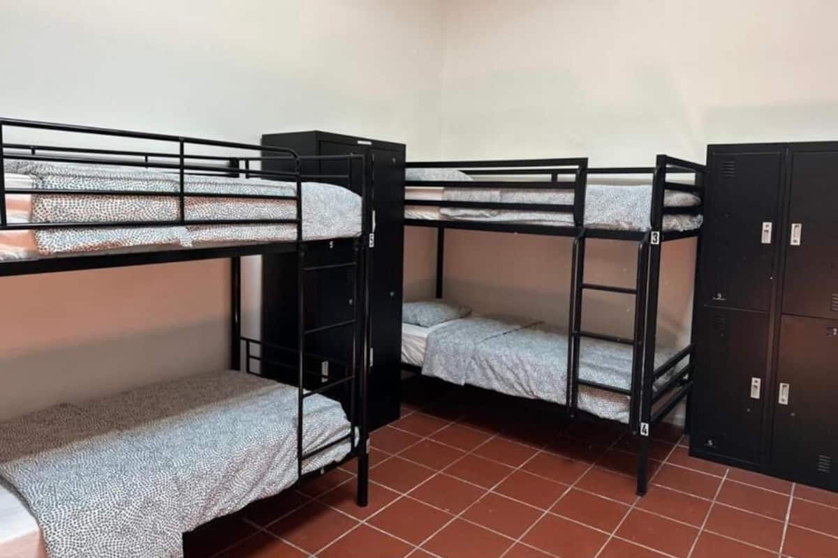 Une chambre de dortoir avec des lits superposés et une armoire.