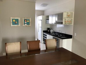 Enjoy meals at the dining table with a glass top and four chairs.