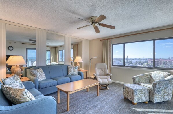 Enjoy a city view from the large window, relax in the comfortable seating area with a sofa and armchairs, and unwind with a flat-screen TV.
