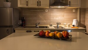 Una cucina moderna con mobili in legno, elettrodomestici in acciaio inossidabile e un vassoio di frutta sul bancone.
