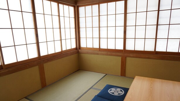 A traditional Japanese room with tatami flooring, shoji screens, and a low wooden table. - Tokiwatei (Hakuba)