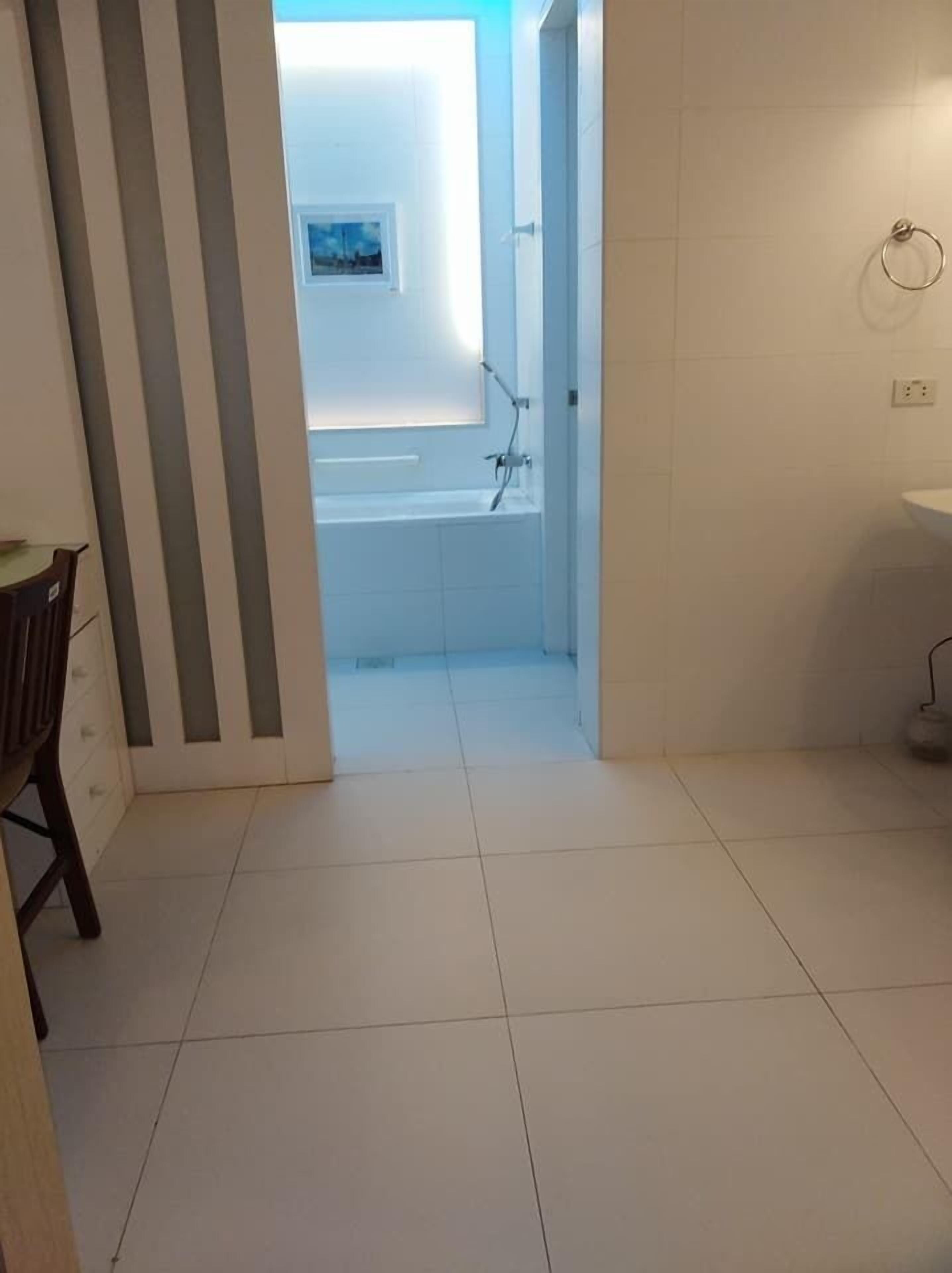 A bathroom with a bathtub, a shower, and a sink.