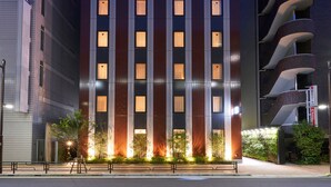A modern hotel with a prominent sign at the top, multiple floors, and a well-lit facade. - Hotel Resol Ueno (Tokyo)