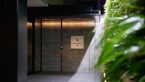 An entrance to a hotel with a sign reading "HOTEL REJOL UENO". - Hotel Resol Ueno (Tokyo)