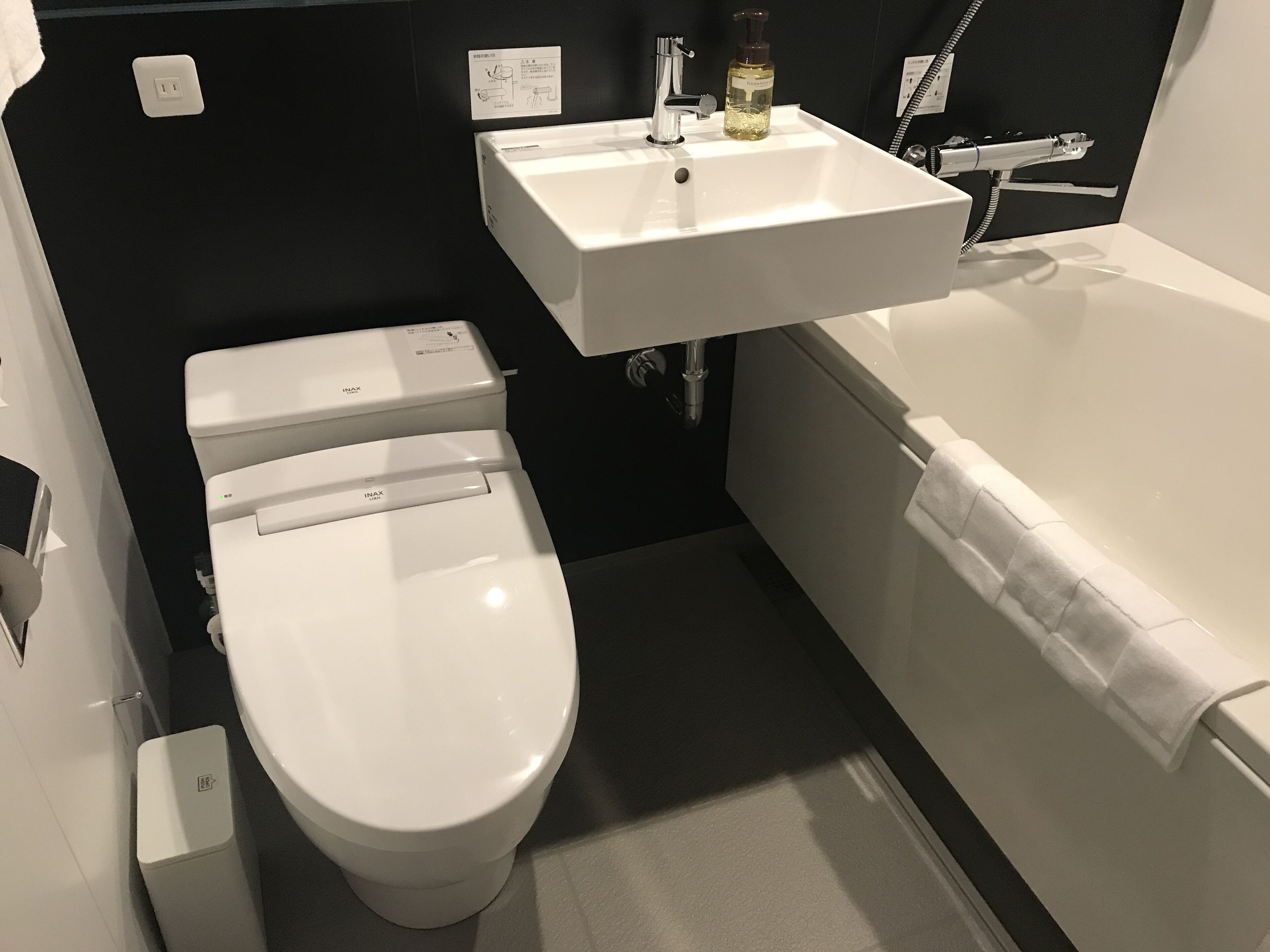 separate bathtub and shower, slippers, towels