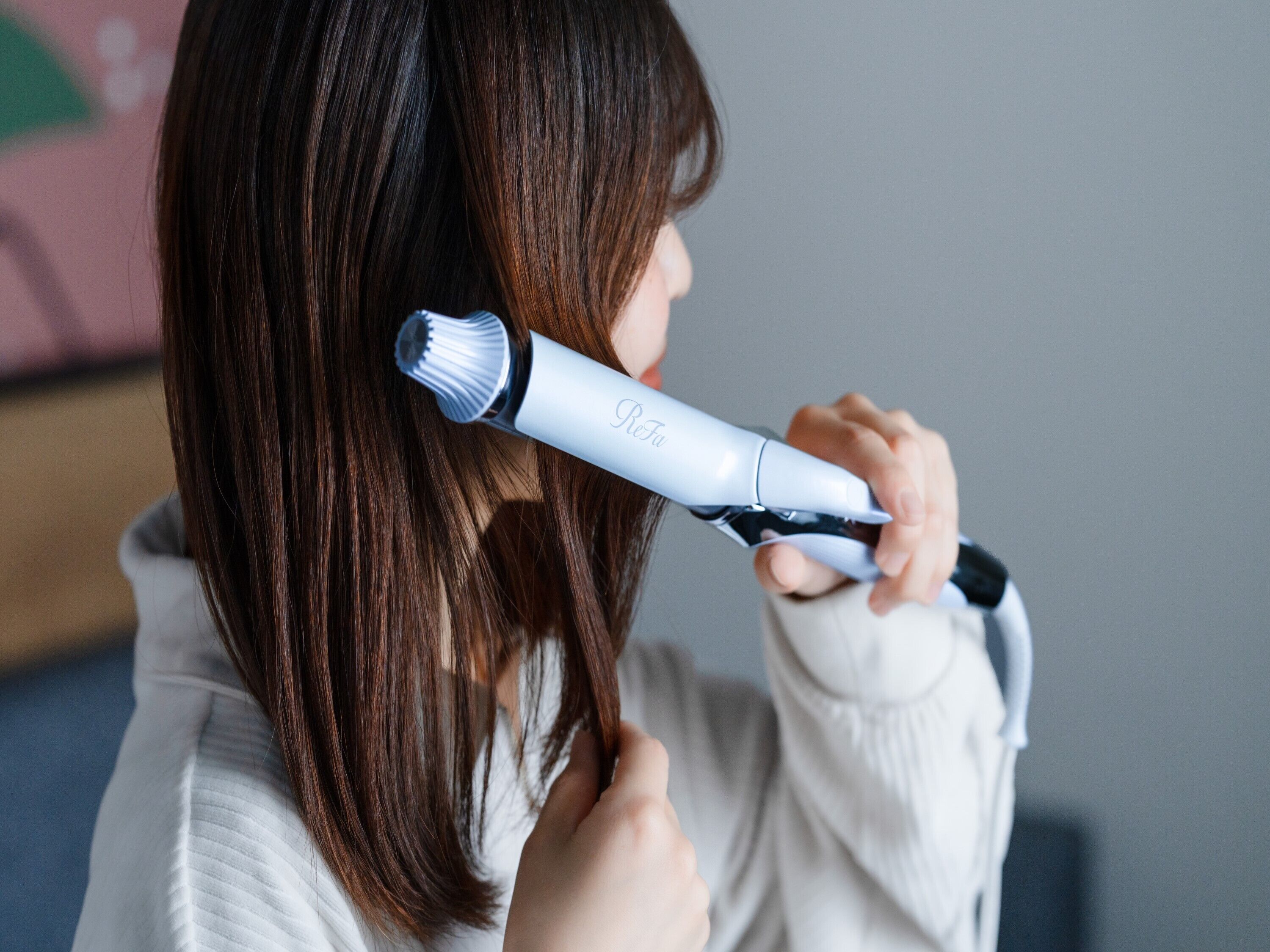 Una persona usando una plancha para el pelo.