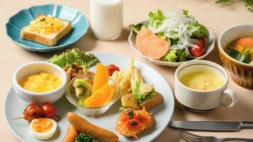 A variety of breakfast foods including toast, eggs, sausages, and a salad on a plate.