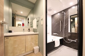 A modern bathroom with a large mirror, a sink, and a shower area. - Hotel Torifito Kashiwanoha (Kashiwa)