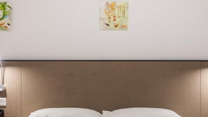 A neatly made bed with white linens in a hotel room. - Floral Hotel Dianhu Holiday Shanghai (Shanghai)