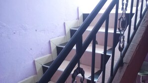 A staircase with black metal railings and beige steps. - Dream Light Hotel (Matuu)