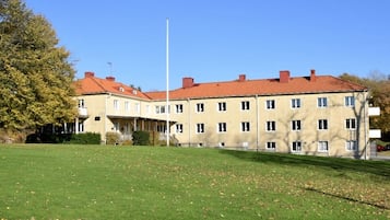 Stunning two-story building with a symmetrical facade and red-tiled roof.