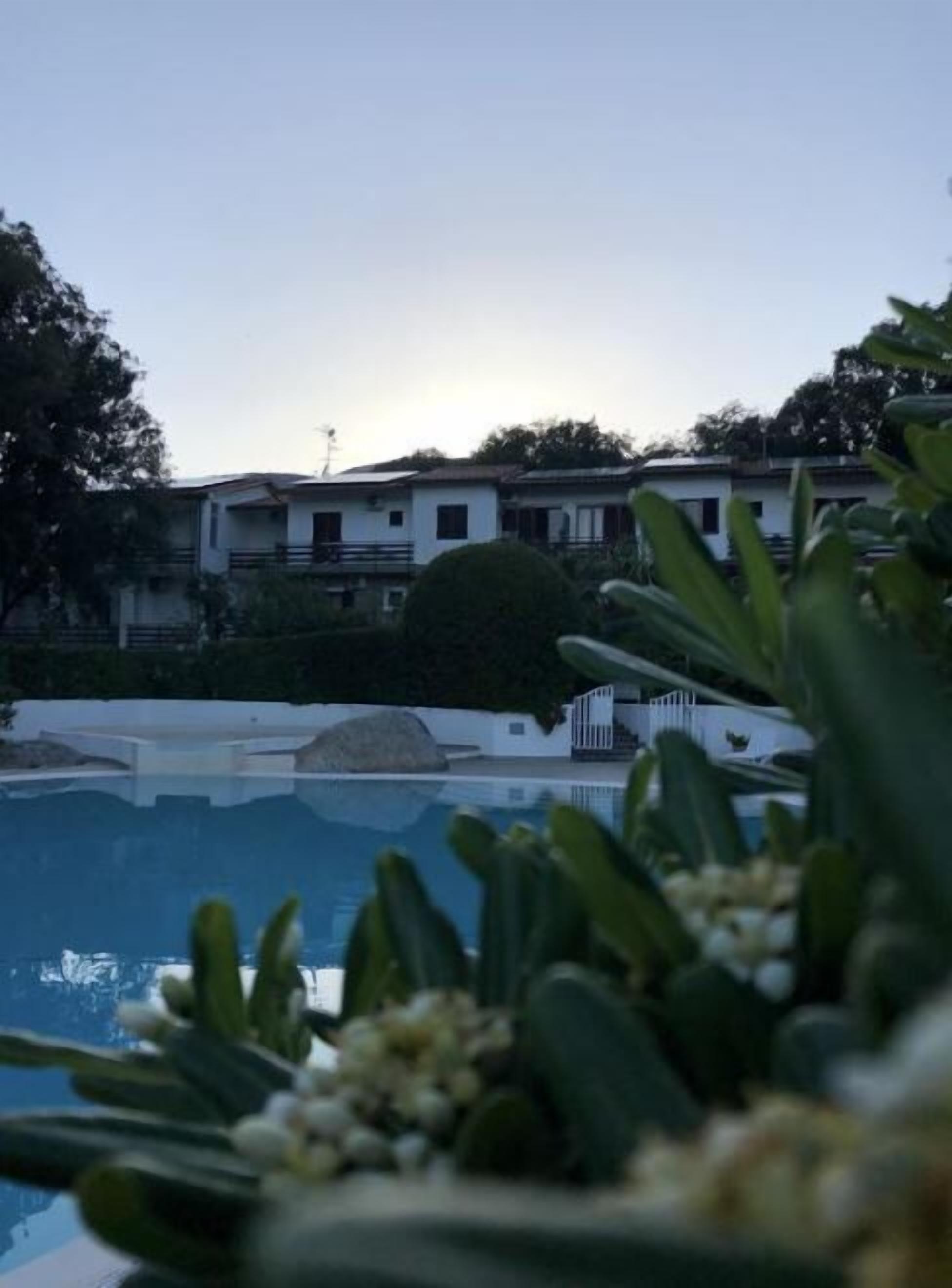 A swimming pool with a view of a residential building in the background.