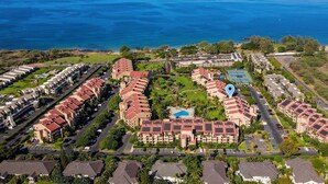 An aerial view of a resort with multiple buildings, a swimming pool, and a view of the ocean. - Kamaole Sands 3-308, Premier Location, Renovated, Large Lanai, Wi-Fi, Split AC!  (Kihei)