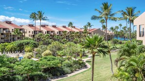 A resort with multiple buildings, palm trees, and a swimming pool. - Kamaole Sands 3-308, Premier Location, Renovated, Large Lanai, Wi-Fi, Split AC!  (Kihei)