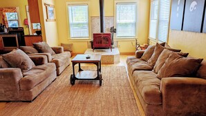 A living room with a fireplace, two sofas, and a coffee table.