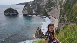 A coastal landscape with cliffs and a beach. - Gus Mank Stay (Penida Island)