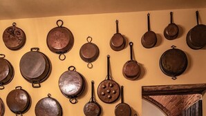 A kitchen with hanging cookware, a tiled backsplash, and a rustic wooden counter with various kitchen items. - Apt. LA TORRE - "Manor of Brunelleschi" Medieval Apartments Resort (Vicopisano)