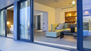 A modern living room with a sofa, a coffee table, and a bookshelf. - Villa Fyki (Lefkada)