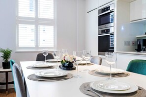 Enjoy dining with family and friends in this spacious dining area, complete with a long table and comfortable seating for four.