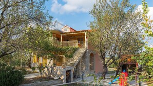 A two-story house with a stone staircase leading to a balcony. - 3 bedroom gorgeous apartment in Skradin (Skradin)