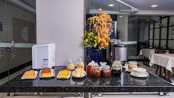 A buffet setup with various food items and a decorative centerpiece.
