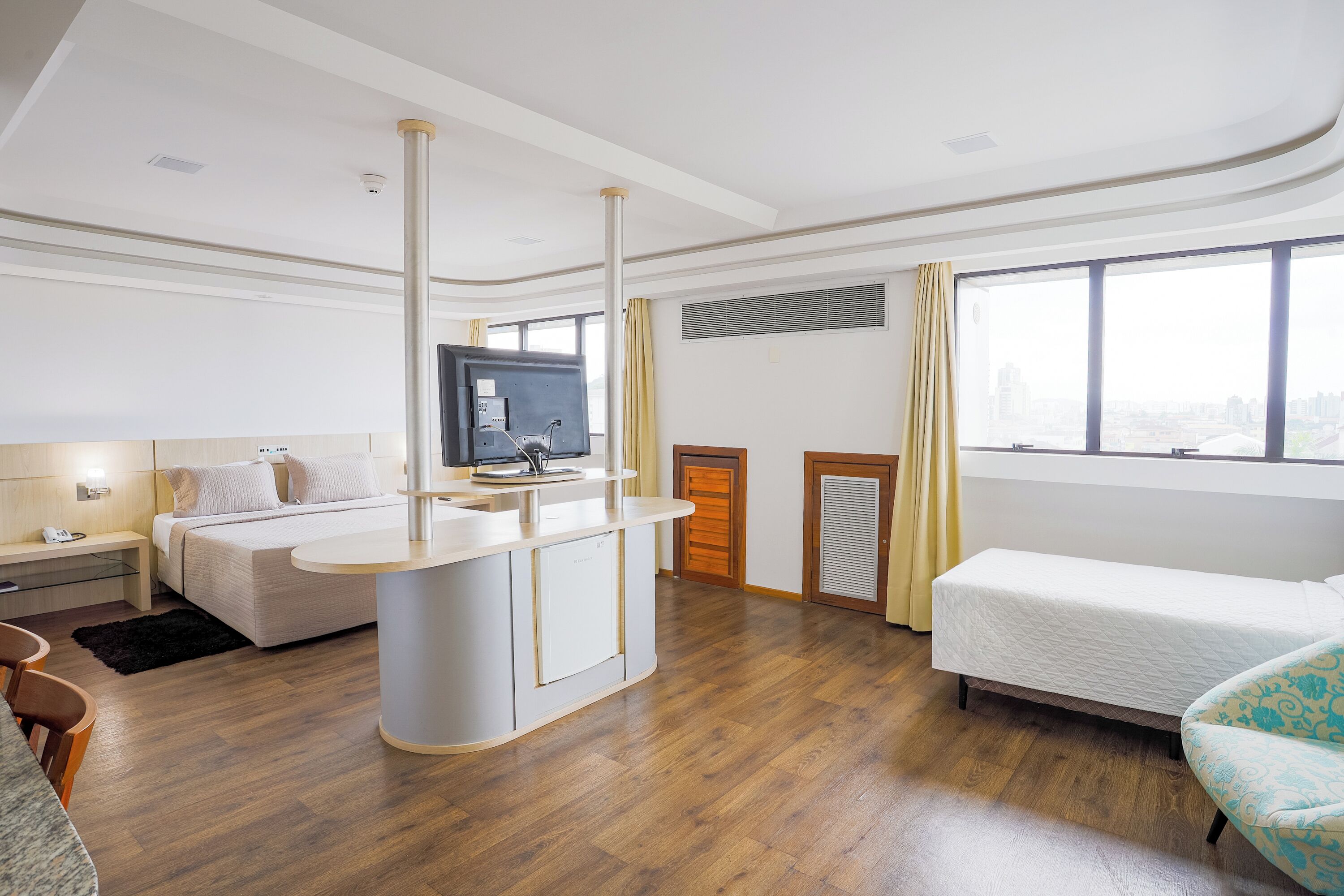 Premium Triple Room | Minibar, desk, laptop workspace, blackout drapes