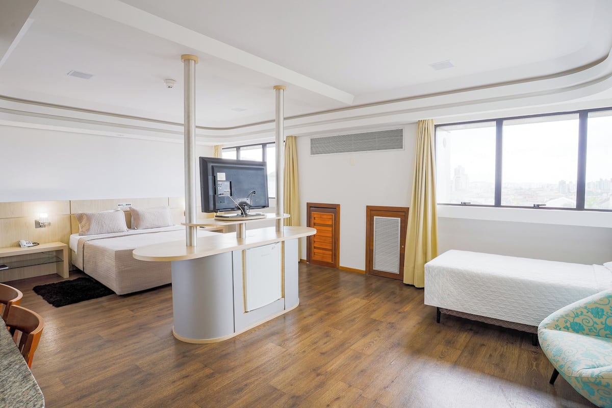 Premium Triple Room | Minibar, desk, laptop workspace, blackout drapes