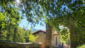 A stone building with a red-tiled roof, surrounded by greenery and a stone wall. - Borgo Mulino,unique setting, private pool,  mountain views WIFI, walk restaurant (Vallico Sopra)