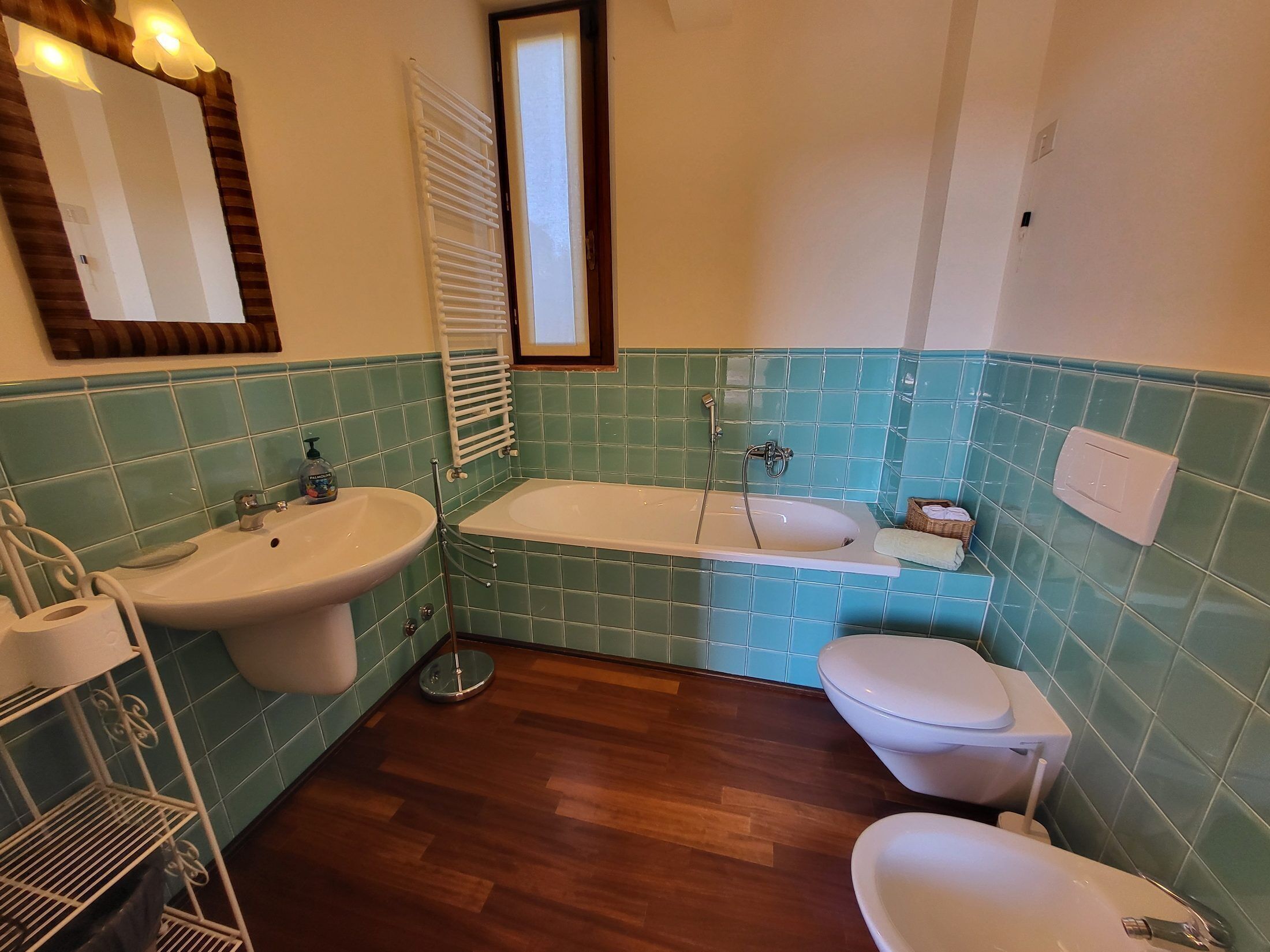 Een badkamer met een wastafel, toilet en badkuip, alles met witte sanitair.