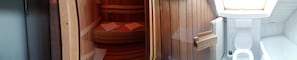 A sauna with wooden benches and a white toilet in a modern bathroom. - Adler Gaststube Hotel Biergarten (Bad Rappenau)