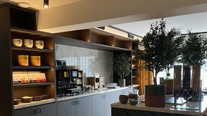 A modern kitchen with built-in appliances, a herringbone-patterned island, and a variety of storage options. - Van der Valk Hotel Gorinchem-A27 (Gorinchem)