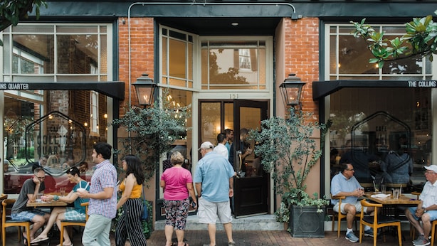A brick building with a cafe and bar named "The Collins".