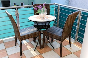 Enjoy al fresco dining in this charming outdoor space with a wicker table and chairs.