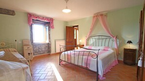 A bedroom with a bed, a nightstand, a dresser, a window with curtains, and a door. - Elcriso, Spacious villa, private pool, amazing views, WIFI, walk to restaurant! (Chiozza)