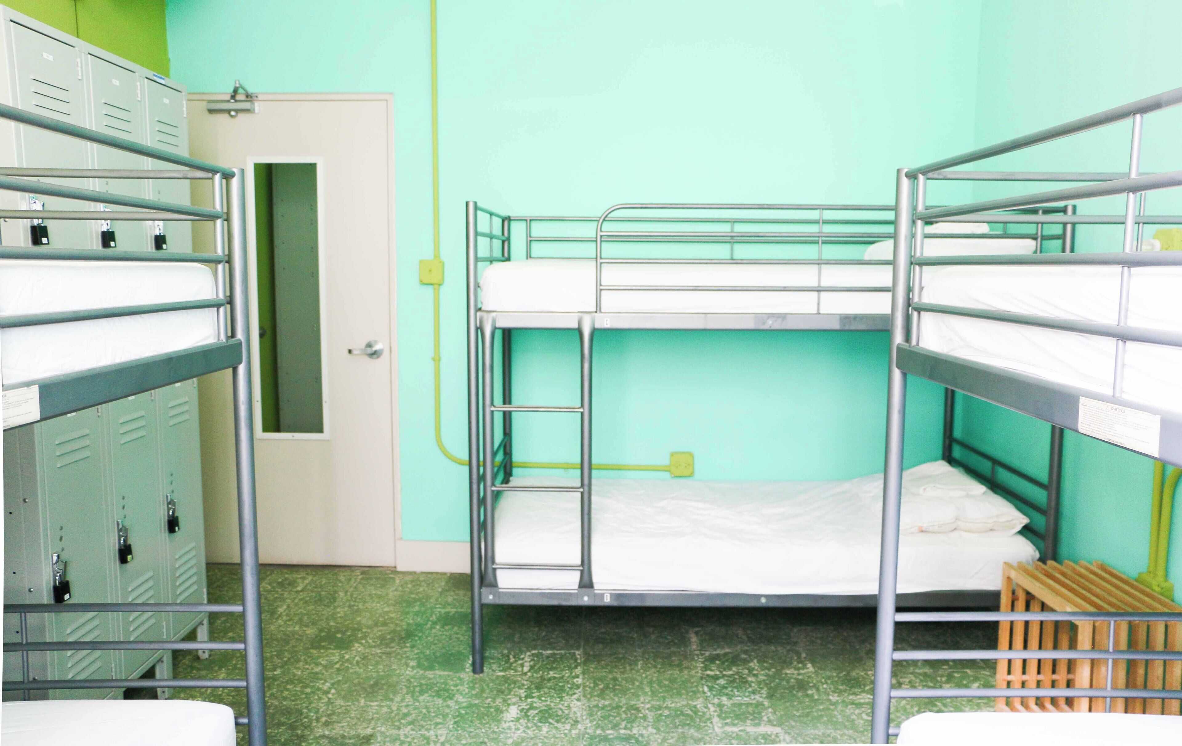 A bunk bed room with lockers and a door.