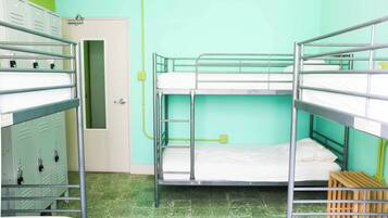 A bunk bed room with lockers and a door.