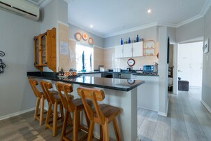 Gratia Apartment 1 | Private kitchen | Full-sized fridge, microwave, cookware/dishes/utensils, dining tables