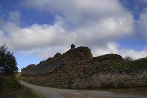 A dirt road leading to a large, rocky hill with sparse vegetation. - Kalliopi Hotel (Minoa Pediada)