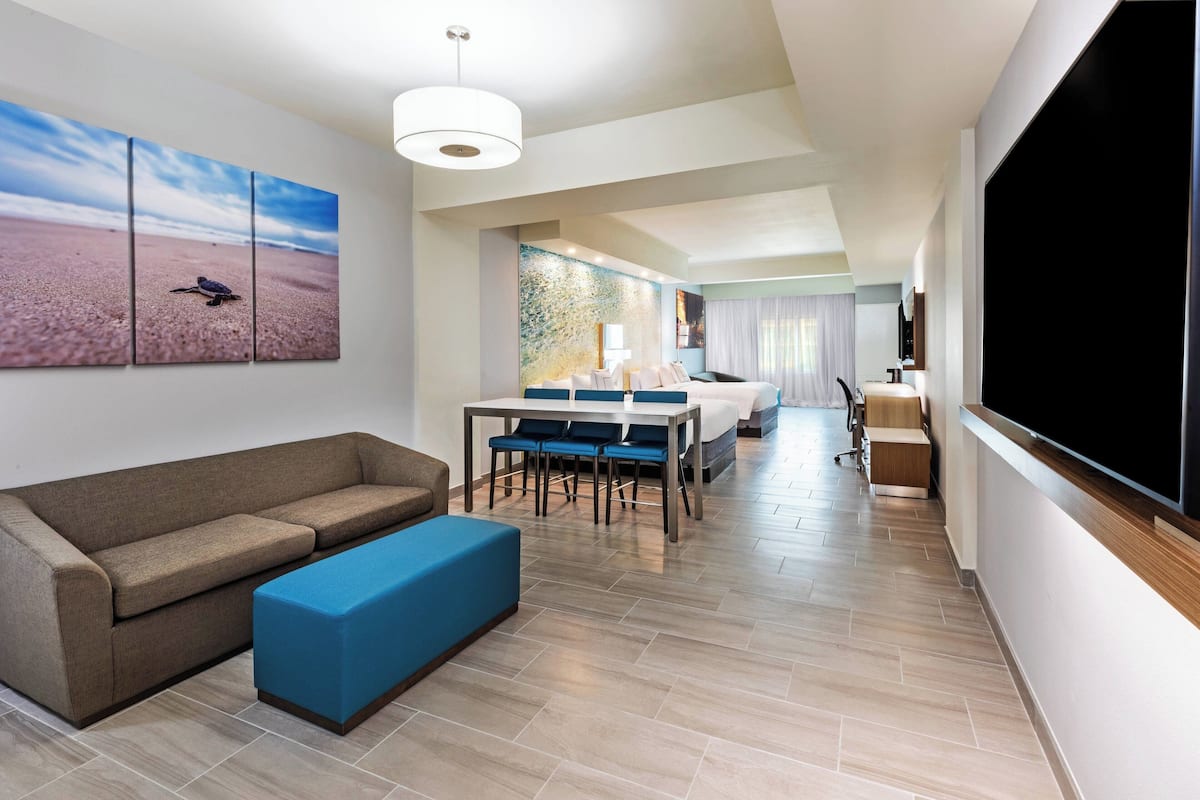 Suite, letti multipli, non fumatori, balcone | Area soggiorno | TV