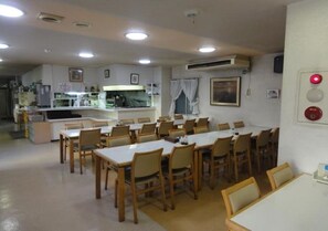 Enjoy group or solo dining in this well-designed space with a long dining table and separate seating area.