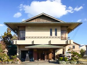 A two-story house with a sloped roof, a front porch, and a garage. - Nonsmoking Standard twin with toilet / Kanazawa Ishikawa (Kanazawa)