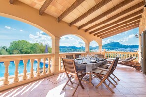 A covered outdoor dining area with a view of a pool and mountains. - SOLLUNA - Villa with private pool and beautiful views to the town of Son Servera, located (Son Servera)