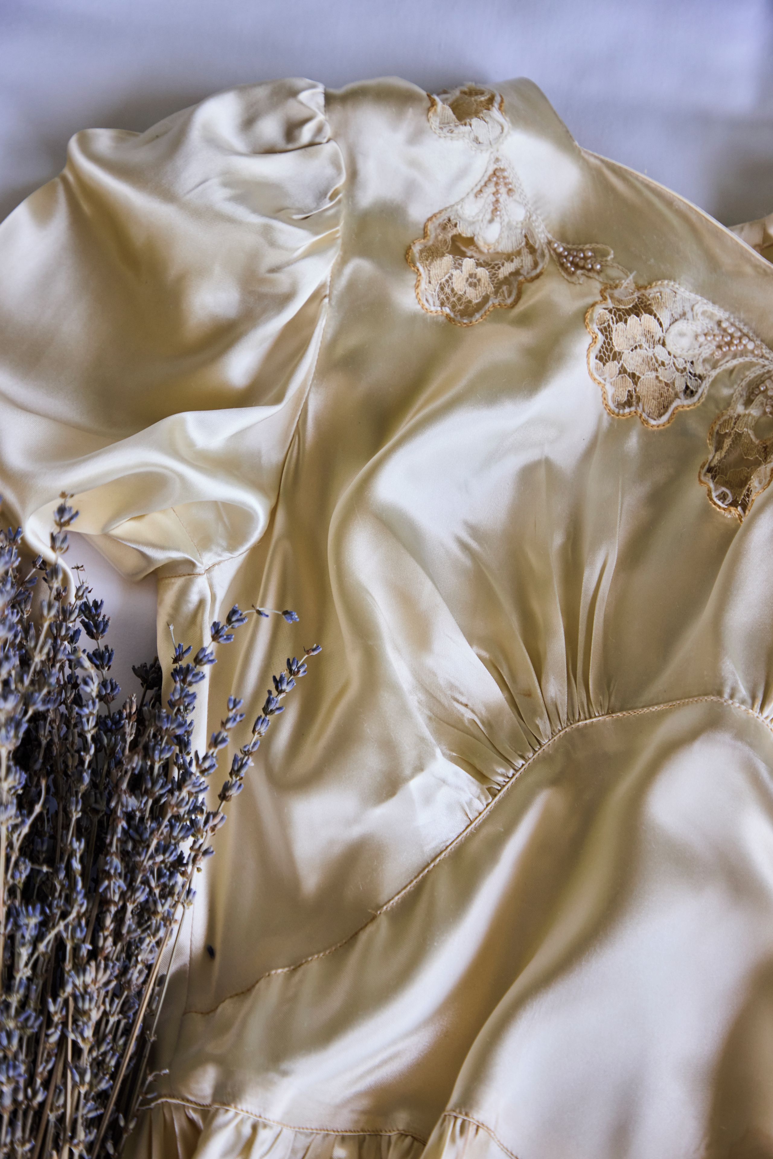 A satin fabric with lace detailing.