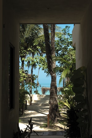 On the beach, white sand, sun loungers, beach bar