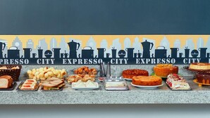 A buffet spread with various food items including sandwiches, pastries, and desserts. - Hotel Cadori (Paicandu)